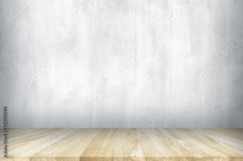 Wood table top with concrete wall background. Used for product placement or montage.