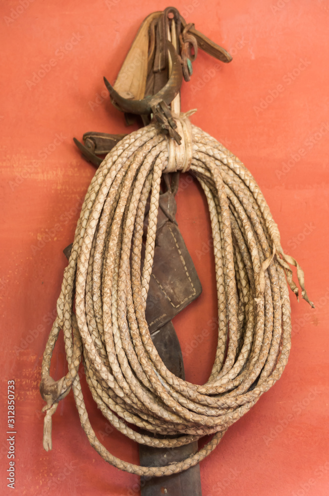 Lasso rope hanging looped on wall hook Stock Photo