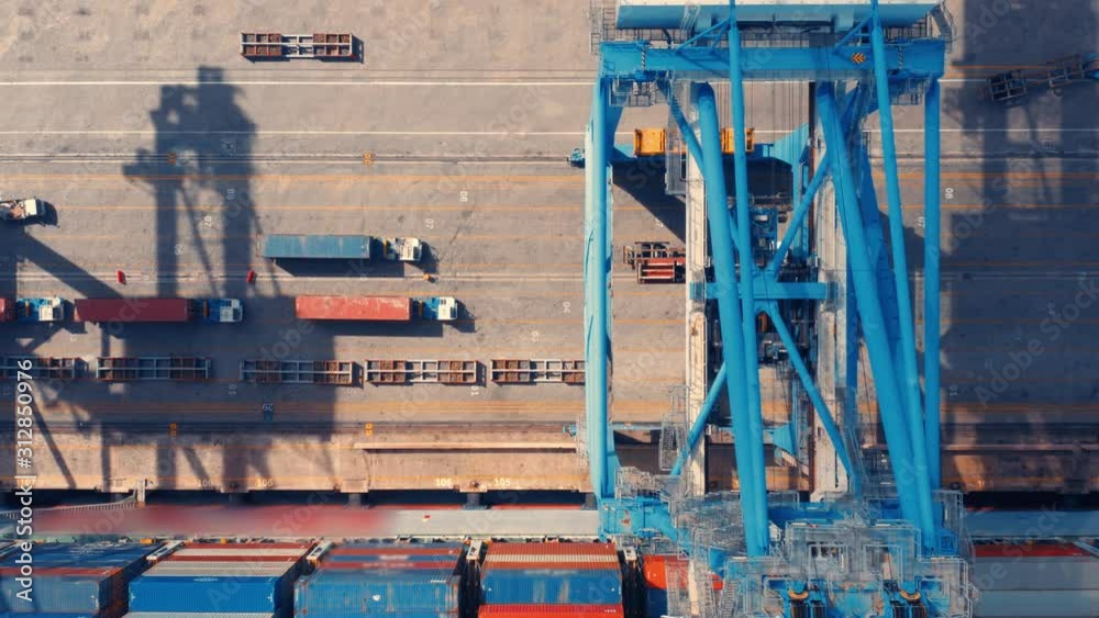 Aerial top view of the seaport with a cargo ships loading/unloading a lot of cargo containers