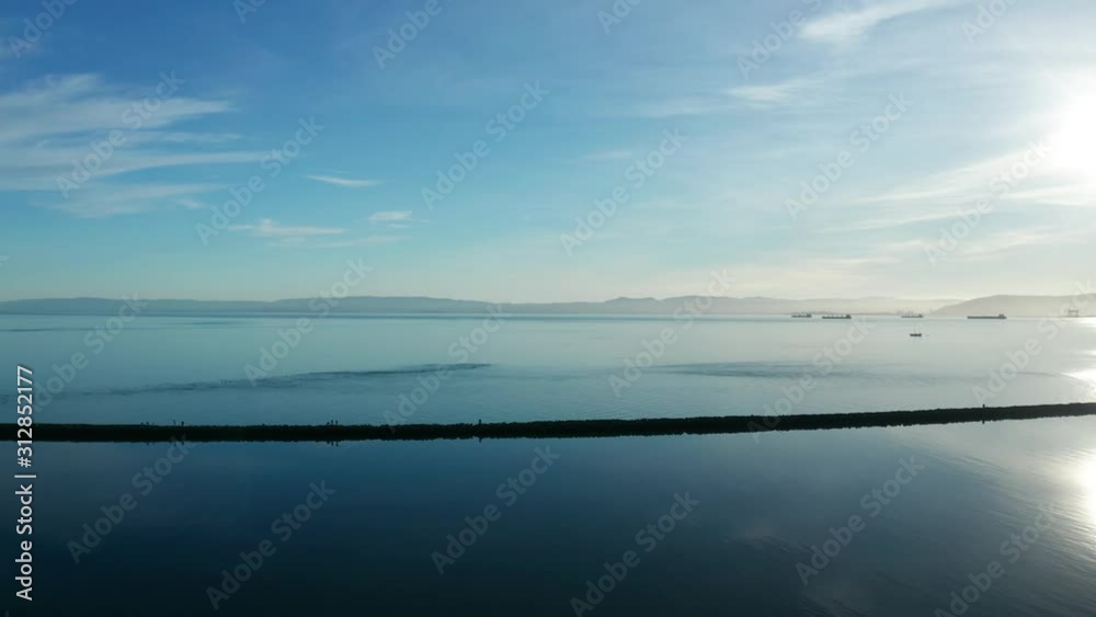 Long shadows over the calm waters of the blue bay city. Long shadows over the calm waters of the blue bay city.