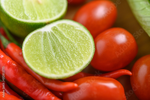 Bright close-up background of lemon slices on tomatoes and peppers