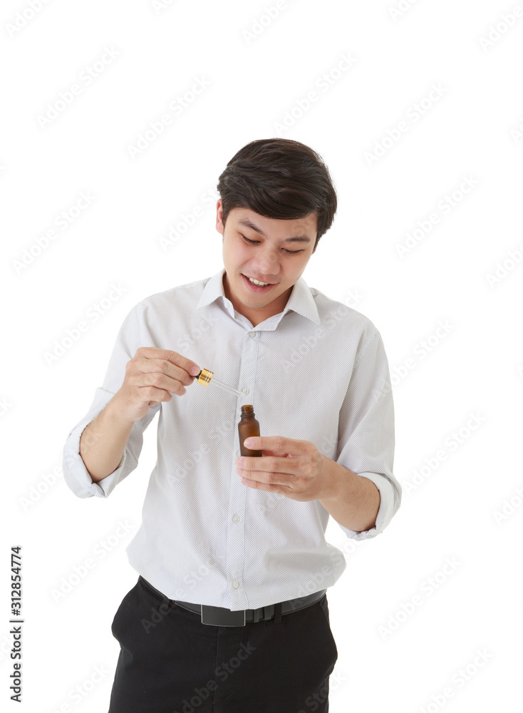 Smiling asian man holding amber glass serum bottle with dropper isolated on white background Smiling asian man holding amber glass serum bottle with dropper isolated on white background