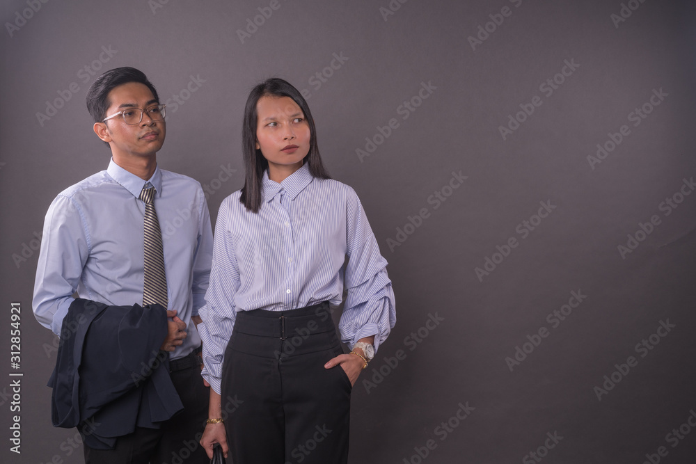 Asian business man and woman.Asian female and male model wearing office attire. Asian business man and woman.Asian female and male model wearing office attire.