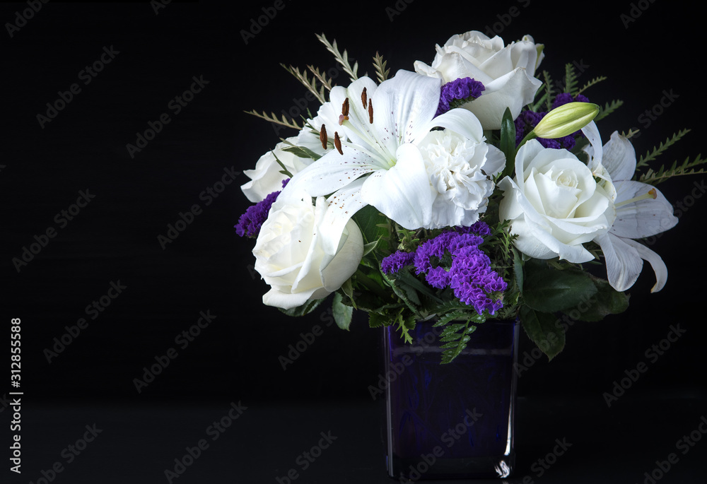 Funeral Bouquet purple White flowers and burning white candle