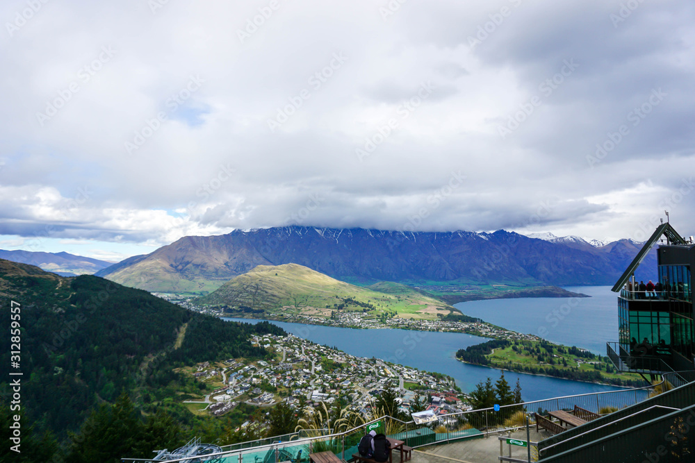 Lake, mountains, trees, sky, clouds in New Zealand.Mountain road, view from above Lake, mountains, trees, sky, clouds in New Zealand.Mountain road, view from above