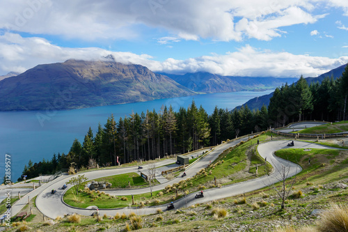 Lake, mountains, trees, sky, clouds in New Zealand.Mountain road, view from above