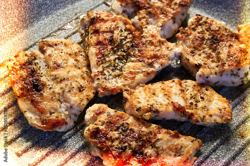 pieces of fried chicken breast. Grilled poultry steak cooked on a grill pan