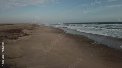 Wallpaper Mural 4K aerial drone video view of Namibian Atlantic coastline, Zeila L-758 Walvis Bay stranded rusty shipwreck at sand beach in Skeleton Coast Park landscape with ocean background at Namibia's west coast Torontodigital.ca