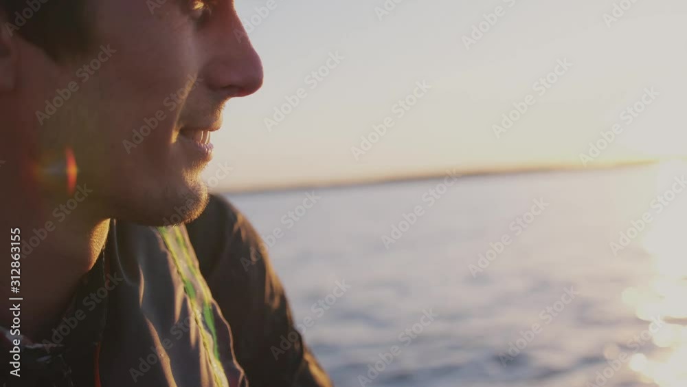 Attractive Man wearing cap Relaxing On Sea Boat At beautiful Sunset. Man Sailing On Boat On Vacation Nature Travel Leisure And Summer Concept. slow motion Attractive Man wearing cap Relaxing On Sea Boat At beautiful Sunset. Man Sailing On Boat On Vacation Nature Travel Leisure And Summer Concept. slow motion