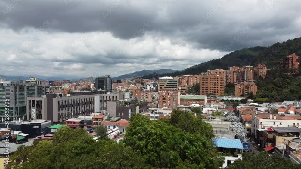 Flying a drone over Bogota, Colombia. Mountains surrounding the city below. Flying a drone over Bogota, Colombia. Mountains surrounding the city below.