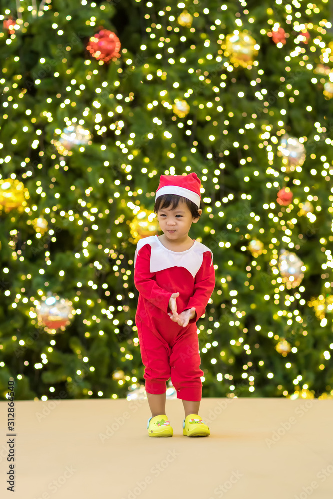 Cute kid Santa Claus in Dance motion. Christmas fun. Baby boy in Santa Shirt colorful and looking happy. Little boy celebrating christmas day wearing a santa hat isolated dancing and having fun. Cute kid Santa Claus in Dance motion. Christmas fun. Baby boy in Santa Shirt colorful and looking happy. Little boy celebrating christmas day wearing a santa hat isolated dancing and having fun.