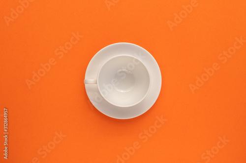 Top view empty white coffee cup on the middle of orange