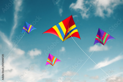 Kites flying with sky background - Image photo