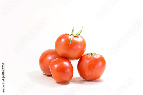 A few tomatoes on a white background.