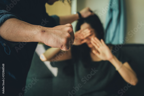 drunk husband hit attacking scared wife in house.help victim of domestic violence, Human trafficking.stop physical abuse women concept © panitan