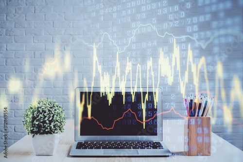 Financial graph colorful drawing and table with computer on background. Double exposure. Concept of international markets.