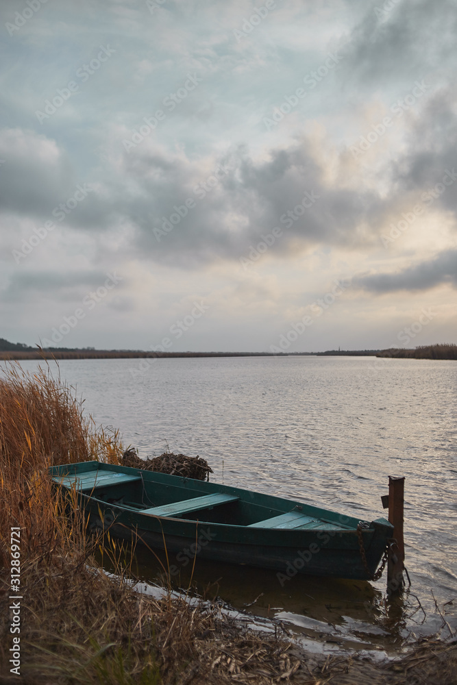 old fishing boat on the lake with beautiful clouds old fishing boat on the lake with beautiful clouds