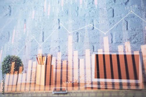 Financial graph colorful drawing and table with computer on background. Double exposure. Concept of international markets.