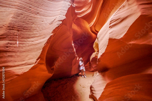 Beautiful hijab asean exploring inside the Grand Canyon, eroded sandstone rock in slot canyon, antelope valley, page, arizona, usa. 