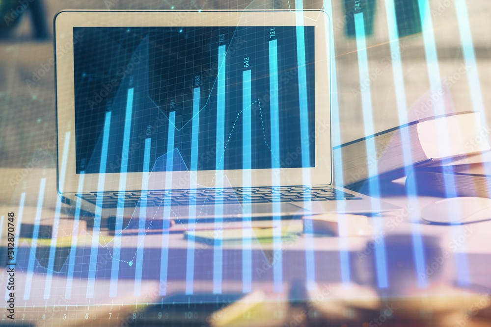 Financial chart drawing and table with computer on background. Double exposure. Concept of international markets. Financial chart drawing and table with computer on background. Double exposure. Concept of international markets.
