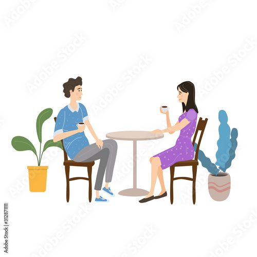 Cute couple sitting at table, drinking tea or coffee and talking in open air cafe