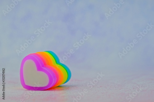 Colorful heart-shape erasers in arrangement for Valentine's day as background with copy space on the right.