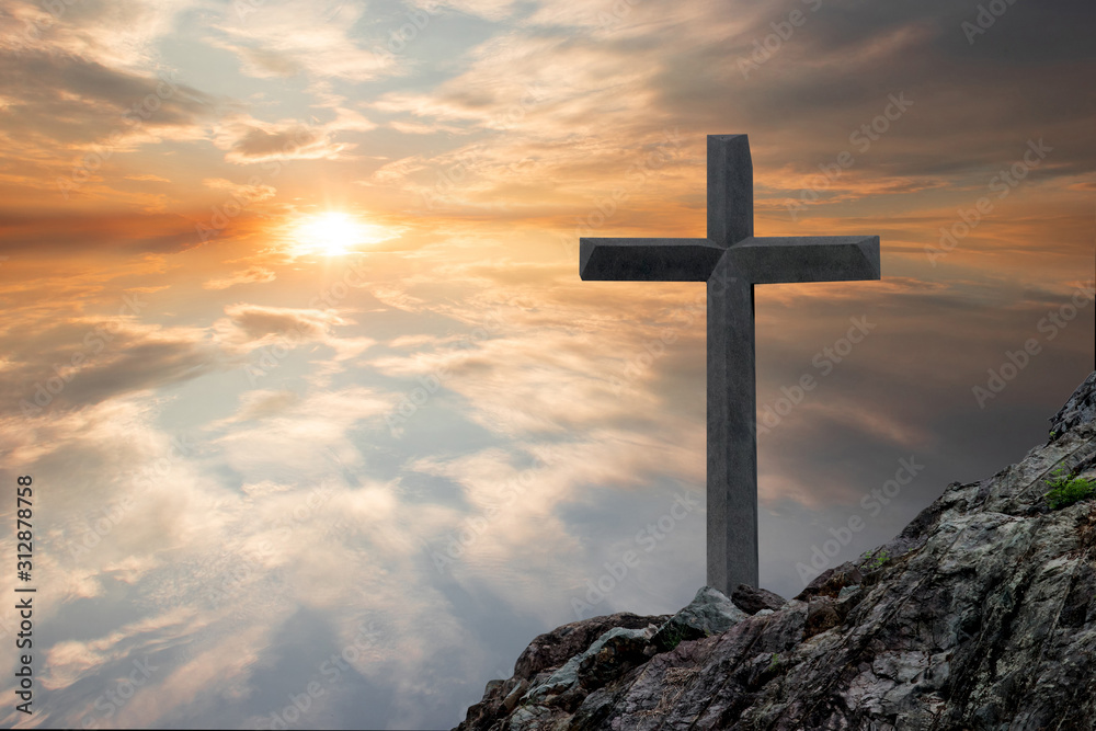 The cross of the crucifixion of Jesus Christ has a sacred sunset background.
