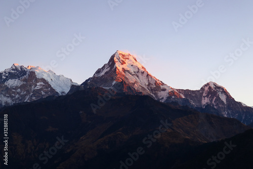Warm pink and orange sunlight at the top of Poon Hill on Annapurna Circuit in Himalaya, Pokhara, Nepal 