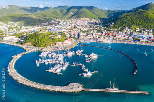 Arial view of Marigot, the main town and capital in the French Saint Martin, sharing the same island with dutch Sint Maarten. Fort St. Louis on a hill, yachts and a circular breakwaters of the marina photo