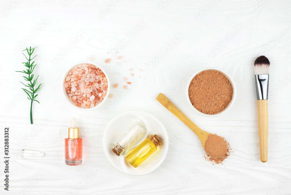 Homemade spa cosmetic set with salt and oil on white wooden background. Copy space. Flat lay style. Homemade spa cosmetic set with salt and oil on white wooden background. Copy space. Flat lay style.