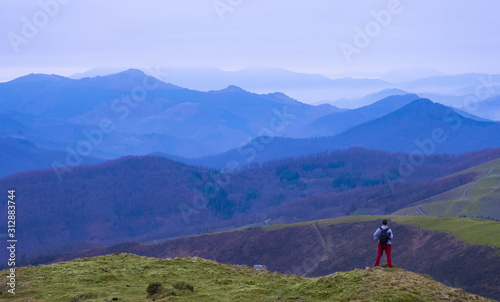 Mountaineer on Mount Bunaniarri with the Gipuzkoa Mountains in the background