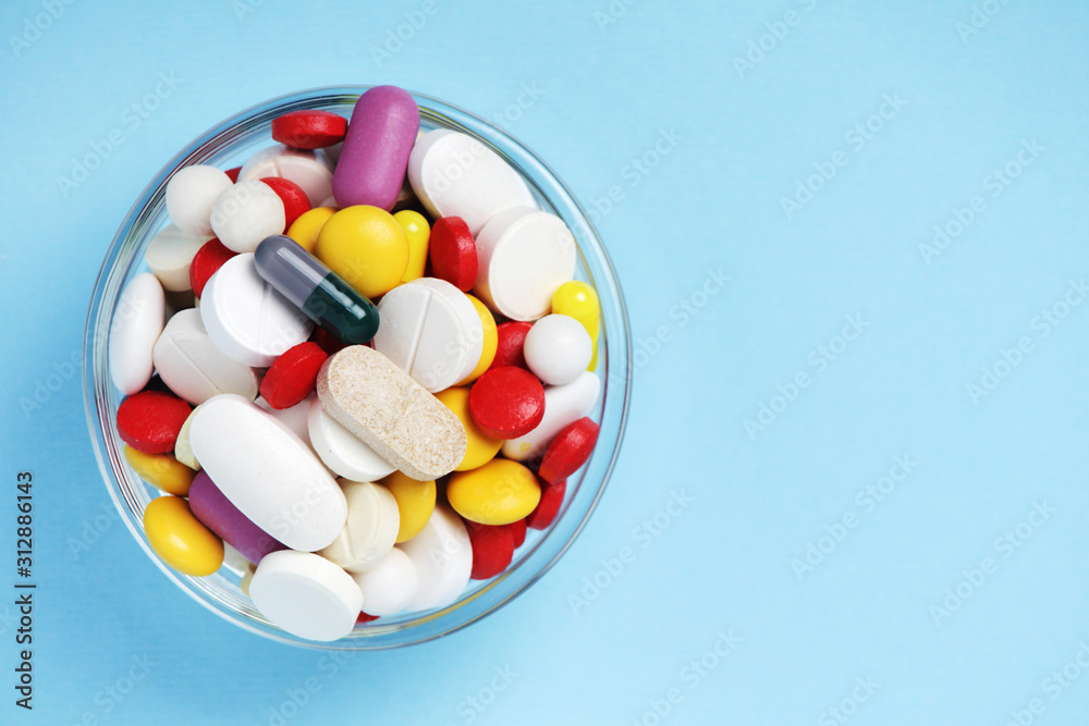 A bowl with colorful medicine pills