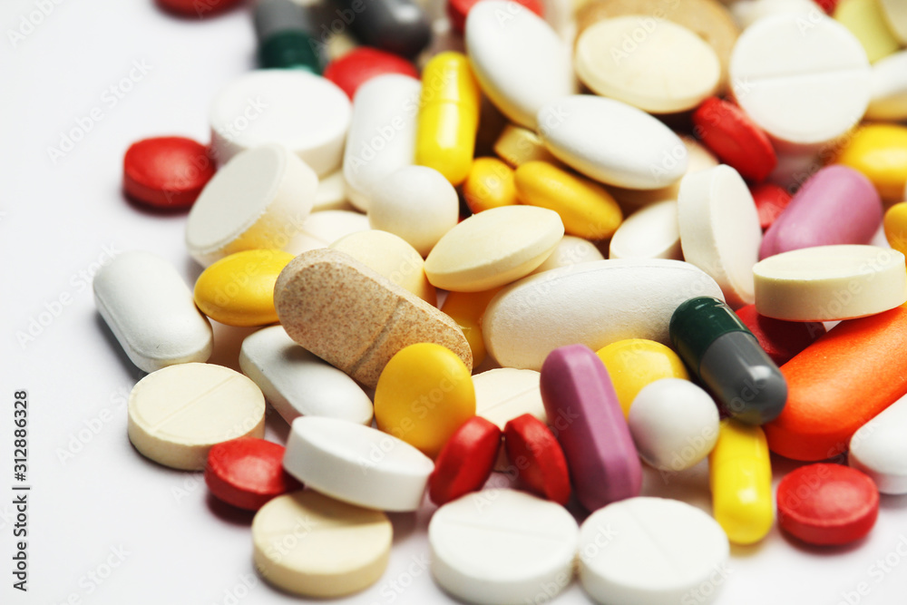 Different colorful tablets at white background Different colorful tablets at white background
