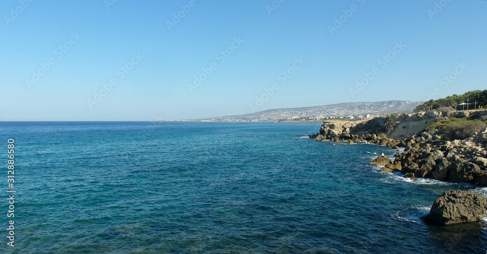rocky shore of the blue sea, waves, sky, top view