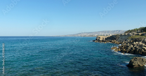 rocky shore of the blue sea, waves, sky, top view