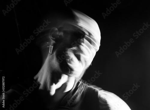 Portrait of a man screaming in soft focus and long exposure