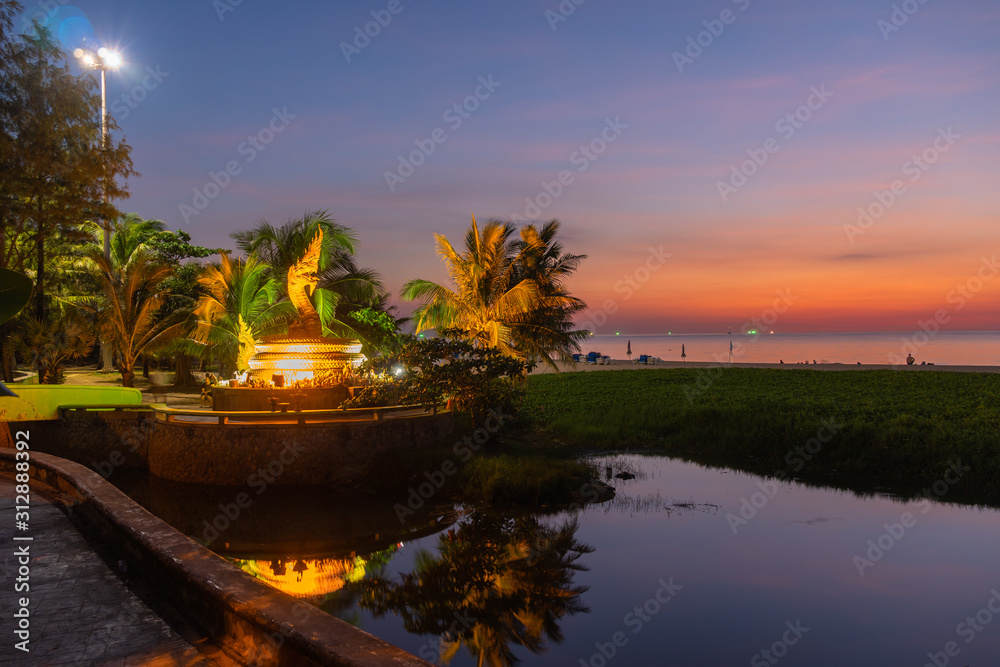 Fototapeta premium sunset behind golden dragon statue on Karon beach Phuket Thailand
