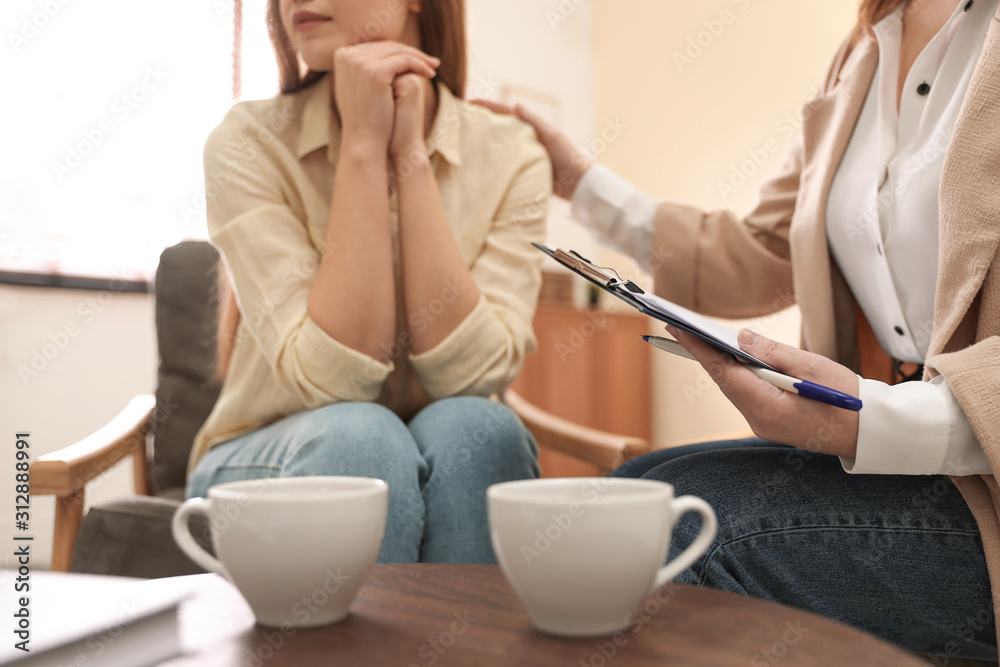 Professional psychotherapist working with patient in office, closeup