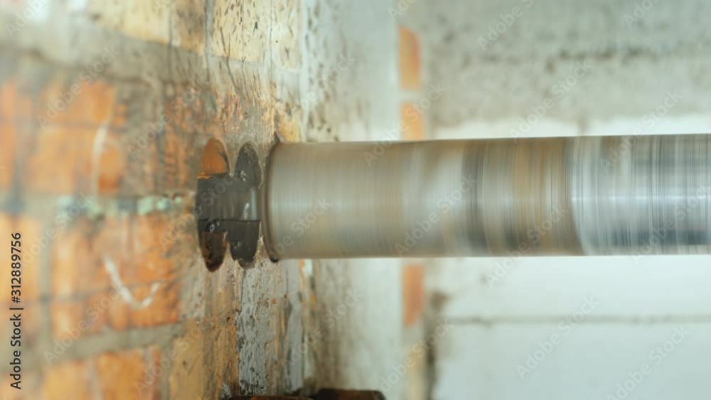 Drilling holes in a brick wall for laying power cables Drilling holes in a brick wall for laying power cables