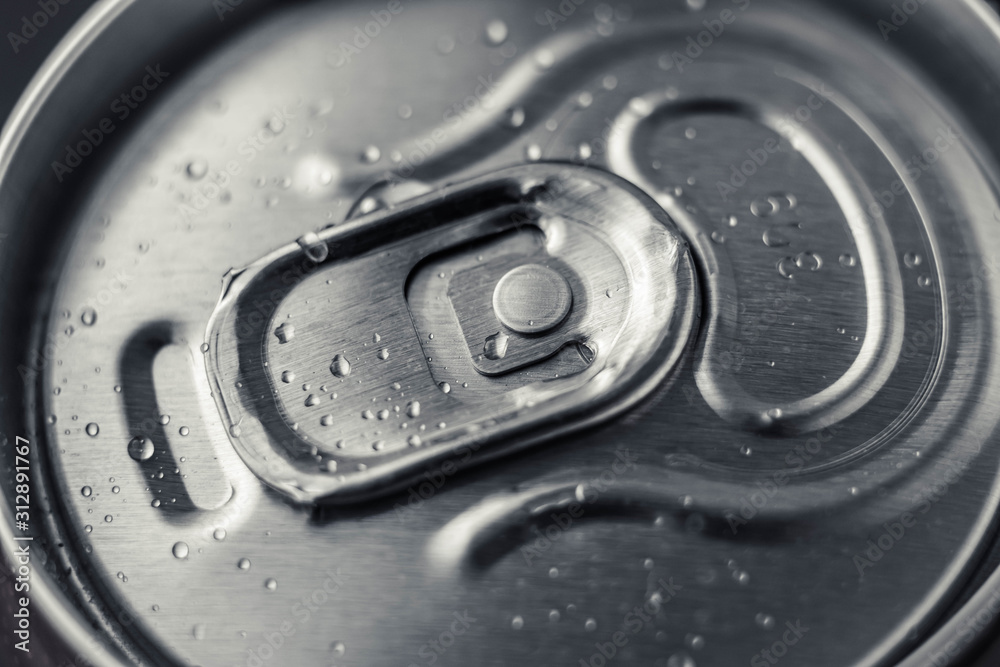 Closed metal can of cola on black background. Top view. Can drink with water drops. Steel shiny bottle of beer. Closed metal can of cola on black background. Top view. Can drink with water drops. Steel shiny bottle of beer.