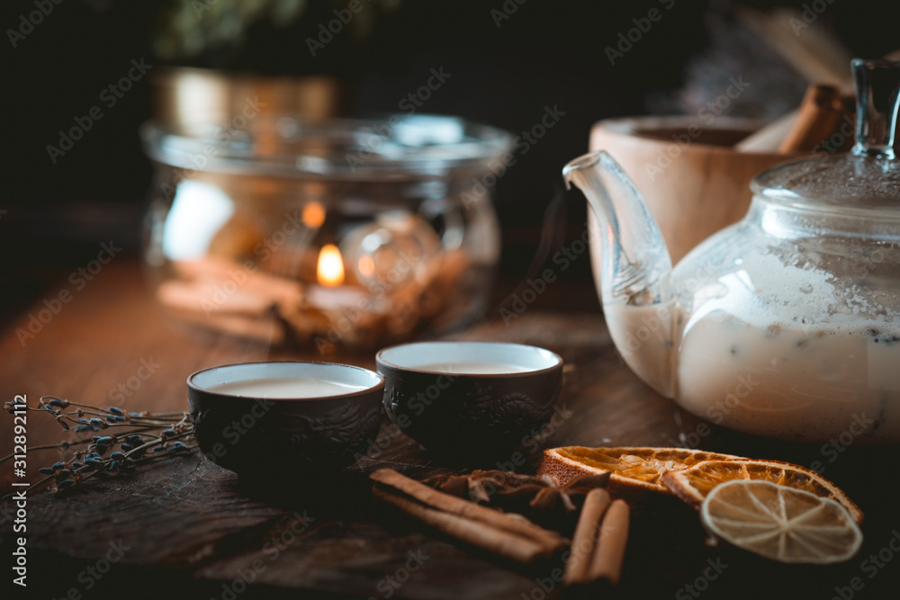 Chinese tea ceremony with ceramic cups with milk Oolong tea on wooden background. Traditional Asian drink, beautiful serving
