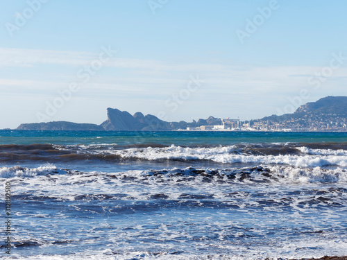 View on Mediterranean sea, shores, calanques and waterfront landscape of La Ciotat, eagle's beak, calanque du Mugel from Sandy beach at Les Lecques in Saint-Cyr-sur-Mer in French Riviera