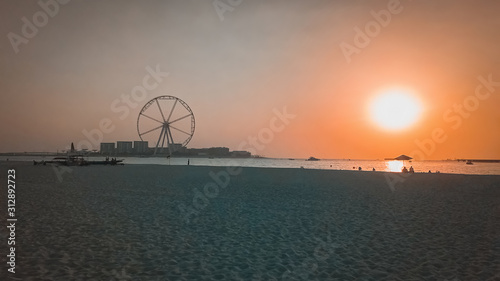 Authentic evening view of the Arabian Gulf with the silhouette of the Ferris wheel in Dubai.