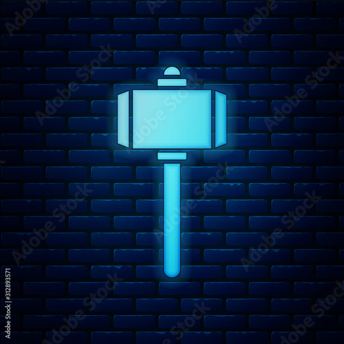 Glowing neon Battle hammer icon isolated on brick wall background. Vector Illustration