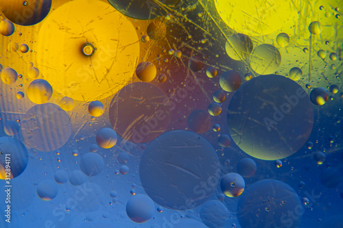 circles and oil bubbles in the water closeup