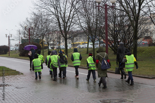  Vest. Group of schoolchildren in Hi-Vis Safety. Safe movement of children around the city.