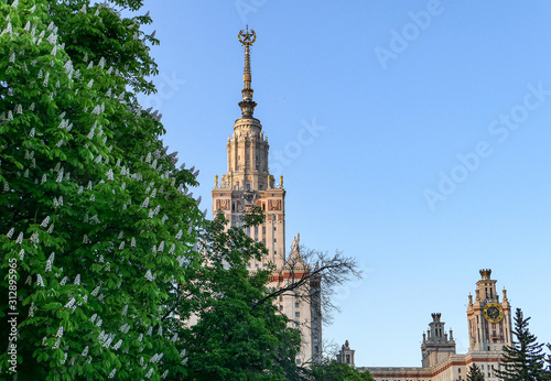 Panoramic view of campus of fanius Russian university with blue sky and green tree branches in Moscow