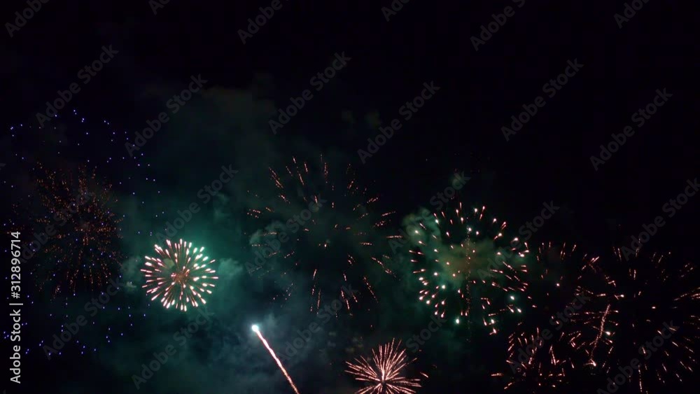 Beautiful abstract colourful Fireworks explode display on sky at night a symbol of celebration in New years anniversary for background