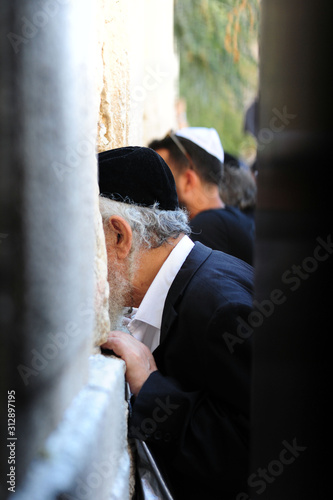 JERUSALEM/ISRAEL - January 12,2020 : Jewish men praying at theWestern Wall or Wailing wall in Jerusalem, Israel. photo