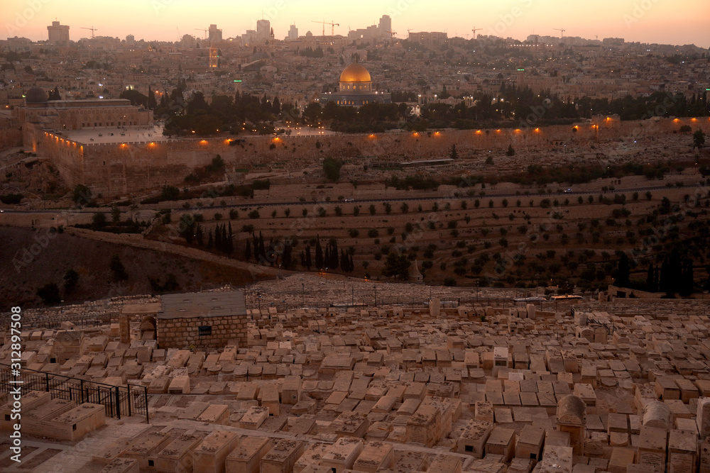 JERUSALEM, ISRAEL - January 2020: The outllok over the jewish cemetery on the Mount of Olives with the Dormition abbey and mosque Al axa in the backgound